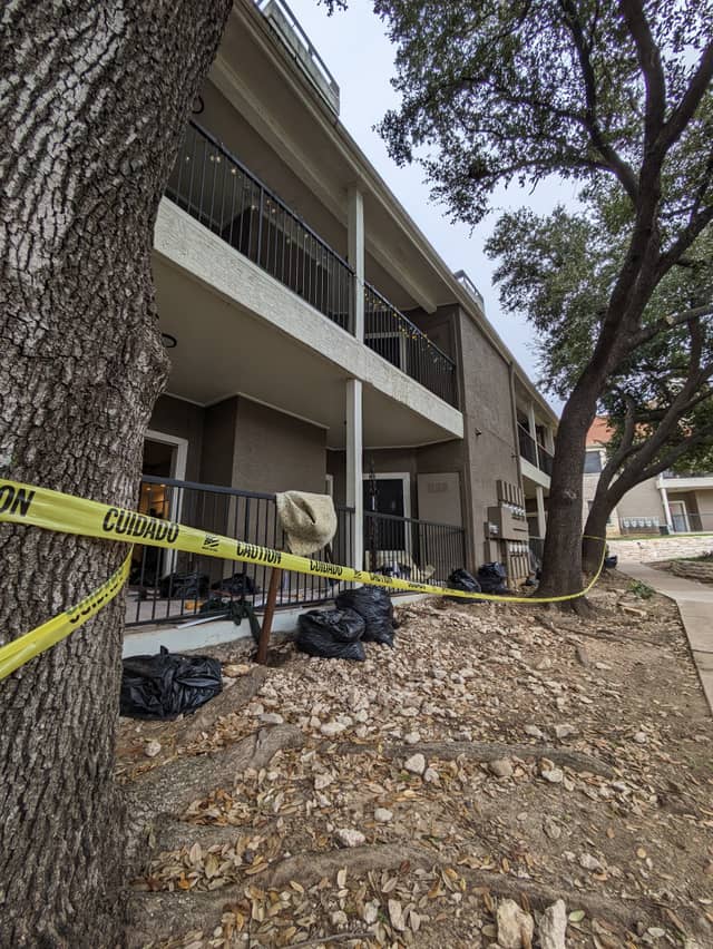 Quality Foundation Repair Austin inspecting an apartment building's exterior for commercial foundation repair.