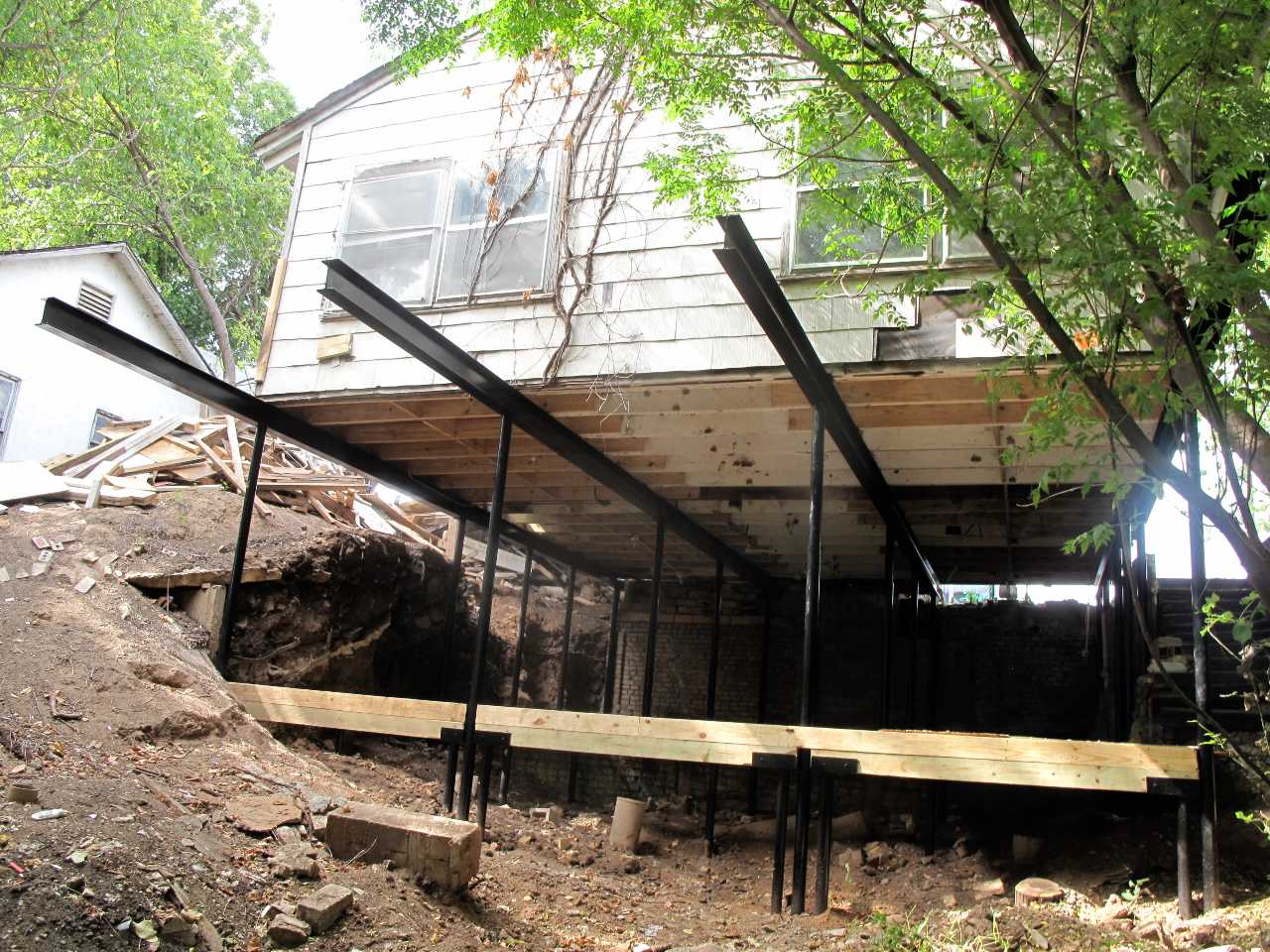 Quality Foundation Repair Austin installing structural steel beams and support jacks for crawl space stabilization.