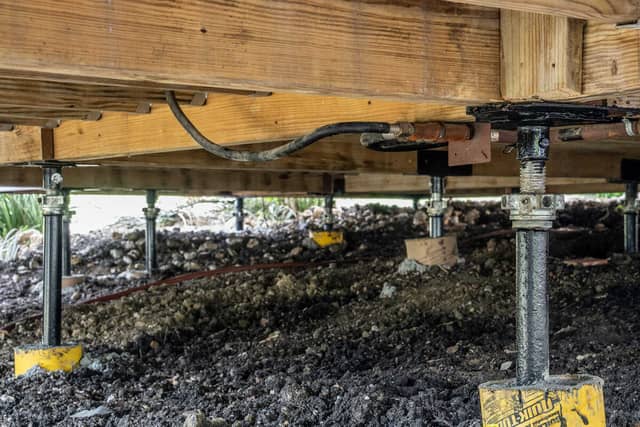 Quality Foundation Repair Austin installing adjustable steel piers for crawl space isolated pier and beam foundation leveling