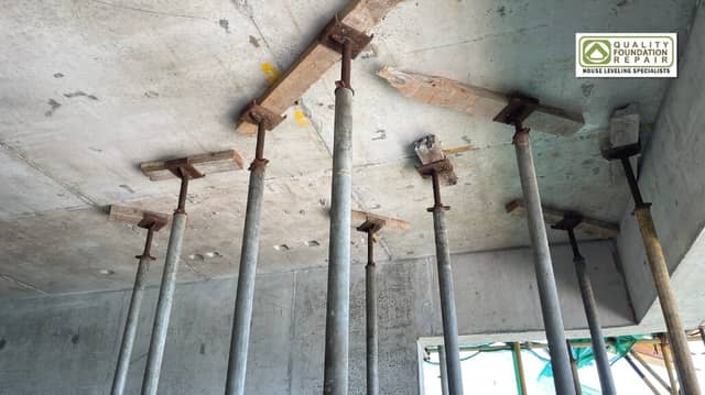 Quality Foundation Repair Austin steel support posts carrying a concrete slab during structural repair.