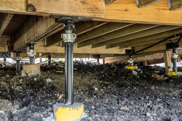 Quality Foundation Repair Austin installing crawl space jacks and support posts for a pier and beam foundation.