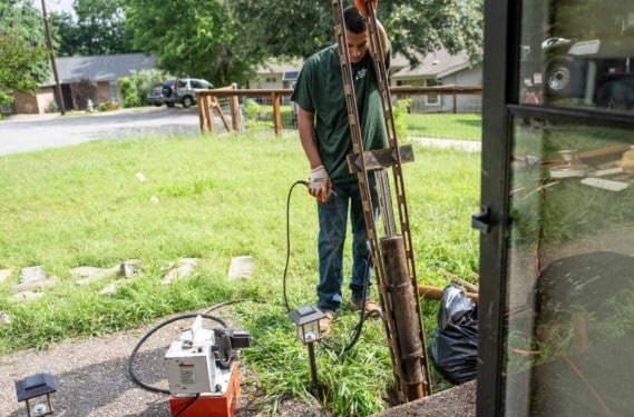 Photo of a man performing foundation repair.